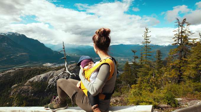 mother and baby looking out over Canadian landscape